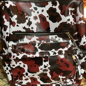 Cow print backpack with a long strap as well
